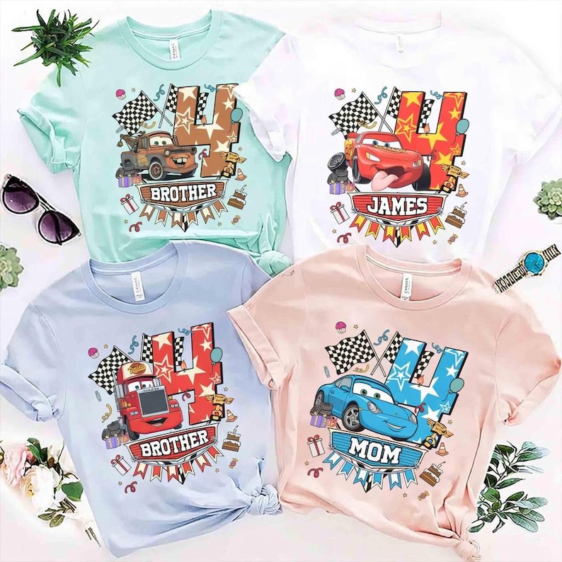 May include: Four t-shirts in pastel colors: mint, white, light blue, and pink. Each shirt features a cartoon car graphic with the number 4 and the words "Brother", "James", "Brother", and "Mom". Checkered flags and birthday cake graphics are also included.