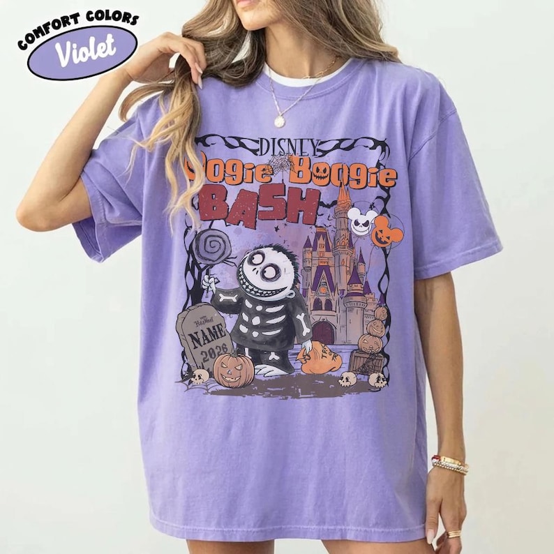 May include: Violet Comfort Colors t-shirt featuring a graphic for the Disney Oogie Boogie Bash. The design includes Jack Skellington, a tombstone, and a castle. The text "Disney Oogie Boogie Bash" is displayed across the top.