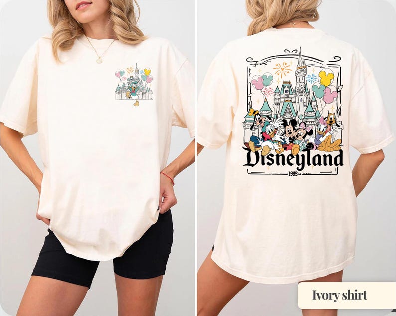Pode incluir: Camiseta marfim com um gr&aacute;fico da Disneyland na frente e atr&aacute;s. O gr&aacute;fico frontal mostra um castelo e bal&otilde;es com o Pato Donald. O gr&aacute;fico traseiro exibe a Disneyland, o castelo e personagens da Disney.