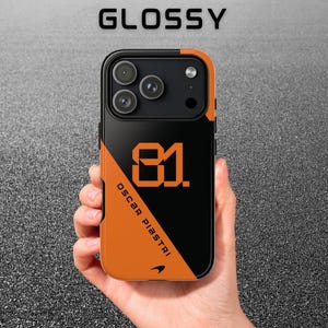 May include: Black and orange phone case featuring the number 81 and the name OSCAR PIASTRI. The case has a glossy finish and a diagonal colour block design. The word "GLOSSY" is printed at the top.