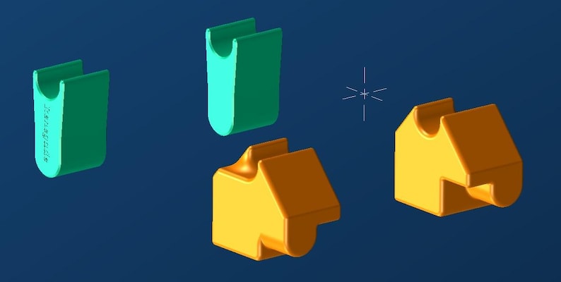 May include: A 3D rendering of several geometric shapes in shades of green and yellow-orange against a dark blue background. The shapes include a U-shaped piece and a house-like shape, possibly components of a larger design.