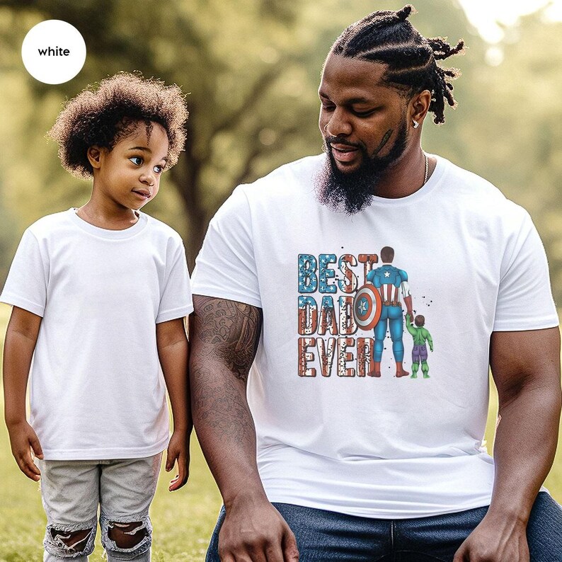 A young girl and an adult man wearing matching t-shirts with a graphic design.