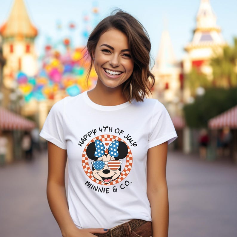White t-shirt with Minnie Mouse in patriotic sunglasses, worn by smiling girl outdoors.