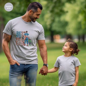 A man and a young girl are standing together in a park, holding hands and smiling.
