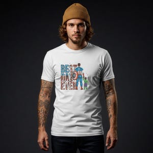 A man wearing a white t-shirt with a graphic design and text printed on it.