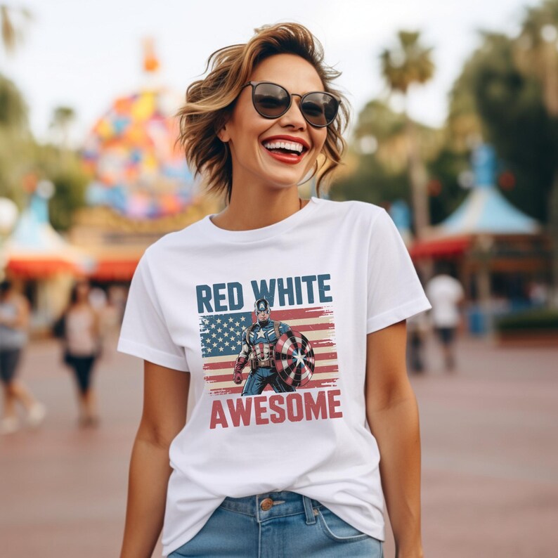 White t-shirt with Captain America and "RED WHITE AWESOME" text, worn by a smiling woman outdoors.