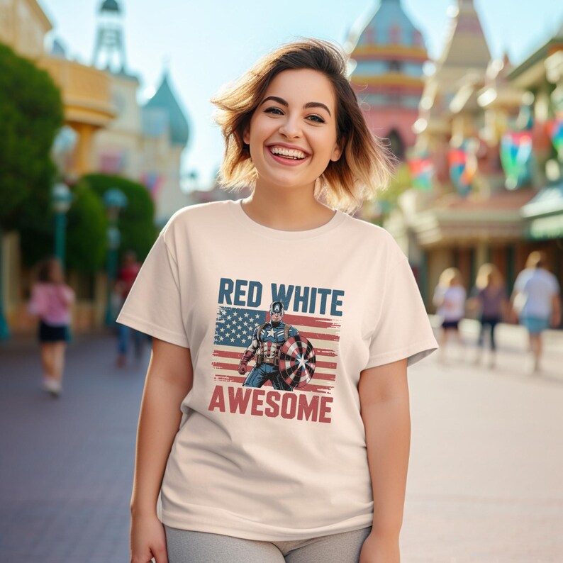 White t-shirt with a Captain America design and "RED WHITE AWESOME" text, worn by a smiling girl outdoors.