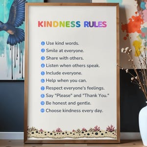 May include: A framed wall art print titled KINDNESS RULES in rainbow-coloured letters. The list includes ten numbered points: Use kind words, Smile at everyone, Share with others, Listen when others speak, Include everyone, Help when you can, Respect everyone's feelings, Say Please and Thank You, Be honest and gentle, and Choose kindness every day.