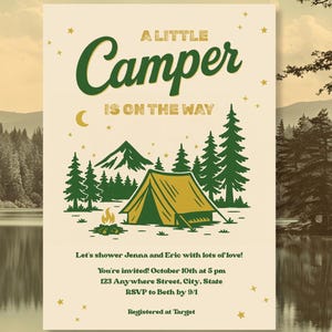 May include: Cream-colored invitation with a camping theme. The text "A Little Camper Is On The Way" is in green. The illustration includes a tent, mountains, trees, and a campfire. Stars and a crescent moon are also featured.