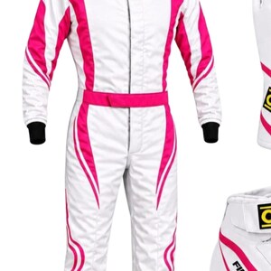 May include: A white racing suit featuring vibrant pink vertical stripes along the torso, arms, and legs. The suit includes a central zipper closure, a waist belt, and black ribbed cuffs at the wrists. A matching white and pink boot is visible.