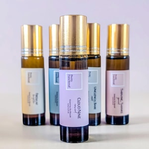May include: A collection of essential oil roller bottles with gold caps and labels. The labels feature the text "Pretty Functional" and various phrases like "Cloud Nine" and "Thriving Thanks". Each bottle contains 10ml / 0.3 fl oz of oil.