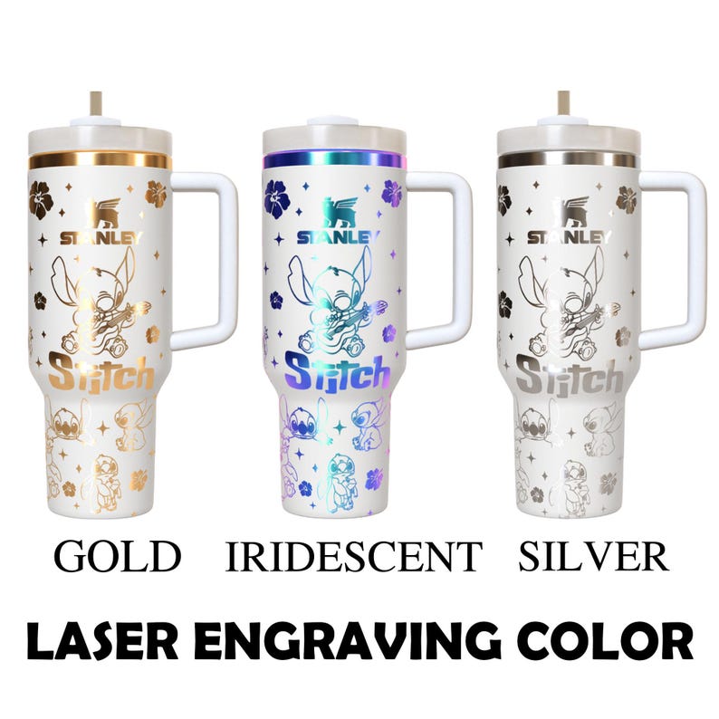 May include: Three white Stanley tumblers with laser-engraved Stitch designs. The tumblers have gold, iridescent, and silver accents, with the word "Stitch" and the Stanley logo. The text "GOLD", "IRIDESCENT", and "SILVER" are below the tumblers.