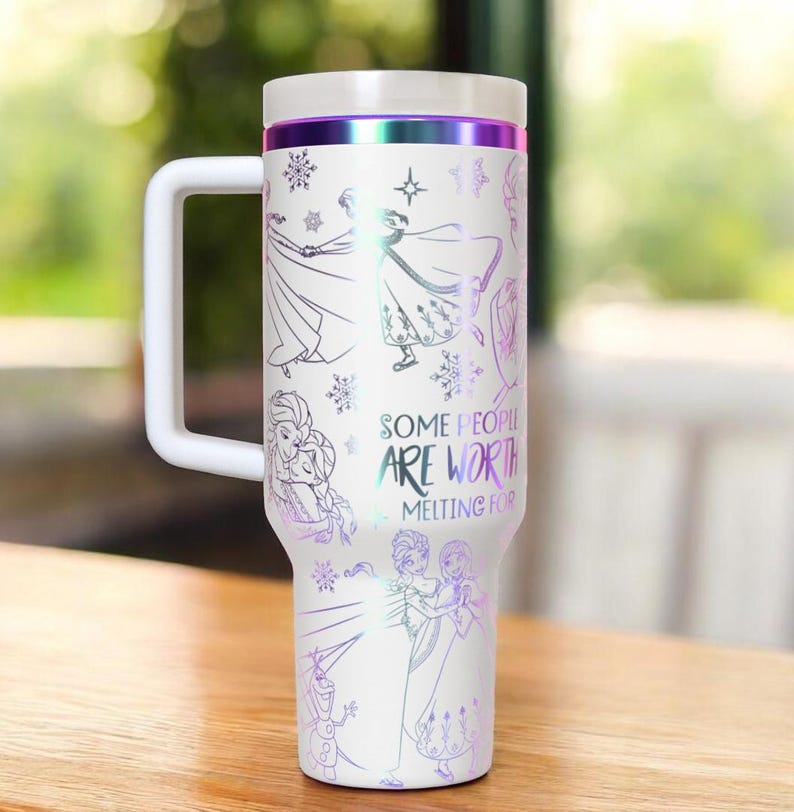 May include: White travel mug with a handle, featuring illustrations of characters and snowflakes. The mug has a white lid and handle, with a purple and silver band. The text "SOME PEOPLE ARE WORTH MELTING FOR" is printed on the side.