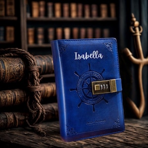 May include: A blue leather journal with the name "Isabella" in white script. The journal features a nautical wheel design and a combination lock. The background includes a bookshelf and antique books.