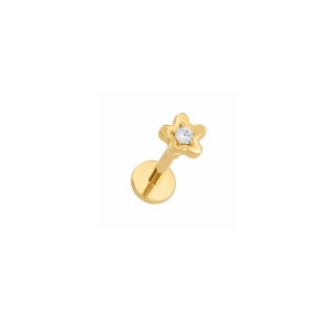 May include: A gold-toned flat back stud earring featuring a five-pointed star shape with a single clear, round-cut gemstone set in the center. The post is attached to a circular flat base, designed for secure placement in a piercing.