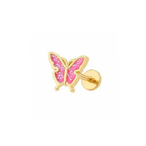 May include: A gold-tone stud earring featuring a butterfly-shaped charm with bright pink enamel wings and subtle white glitter accents. The earring includes a flat circular backing post, showcasing a metallic gold finish throughout the design.