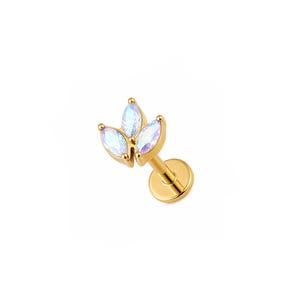 May include: A gold-colored lip piercing featuring three iridescent, marquise-cut gemstones arranged in a floral design. The piercing has a flat back and a threaded post for secure placement. The gemstones reflect a range of colors.