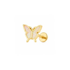 May include: A gold-tone flat back stud earring featuring a butterfly-shaped charm. The butterfly wings are filled with a light pink, glittery enamel inlay. The earring includes a straight post and a circular backing disc for secure attachment.