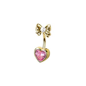 May include: A gold-toned curved barbell body jewelry piece featuring a heart-shaped pink gemstone at the bottom and a decorative bow accent at the top. The bow is centered with a small white pearl-like bead, and the metal has a polished finish.