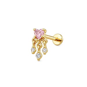 May include: A gold-colored earring with a pink heart-shaped gem at the top and three dangling clear gems. The earring has a flat back and a post for piercing. The design is delicate and feminine.