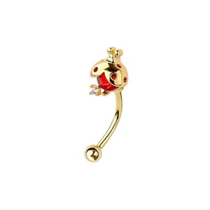 May include: A curved eyebrow ring in gold-tone metal. The charm is a ladybug with a red body, gold spots, and a small clear gem. The ring has a ball at the bottom.