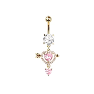 May include: Gold-colored belly button ring with a clear gem at the top and a pink heart pendant. The heart is pierced by a gold arrow and surrounded by small clear gems. A smaller pink heart hangs below.