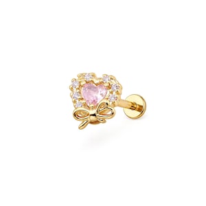 May include: A gold-coloured earring featuring a pink heart-shaped gemstone surrounded by small white gemstones. A gold bow is below the heart. The earring has a flat back and a post for piercing.