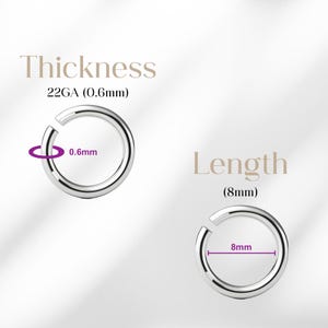 May include: Two silver-colored, open-hoop rings. The text "Thickness 22GA (0.6mm)" and "Length (8mm)" are displayed above and next to the rings. The thickness is 0.6mm, and the length is 8mm.