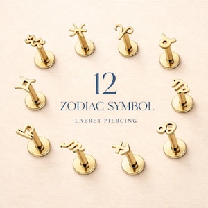 May include: Gold-colored labret piercings featuring the 12 zodiac symbols. Each piercing has a post and a flat disc base. The text "12 ZODIAC SYMBOL LABRET PIERCING" is displayed in navy blue.