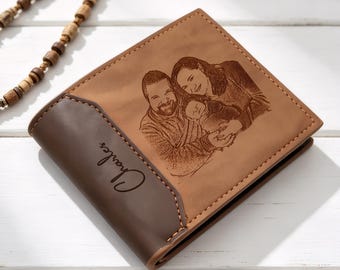 May include: A bi-fold wallet in two-tone brown leather featuring a laser-engraved portrait of two adults and a baby on the front panel. The darker brown side section is embossed with the name Charles in a cursive script font with visible stitching.