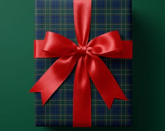 May include: A rectangular gift box wrapped in dark blue and green plaid paper. The package is tied with a vibrant red satin ribbon that forms a large, symmetrical bow centered on the top surface, featuring long, pointed ends extending outward.