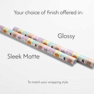 May include: Two rolls of wrapping paper with a repeating pattern of cartoon animals in pastel colours. The text on the image reads "Your choice of finish offered in: Sleek Matte, Glossy. To match your wrapping style."