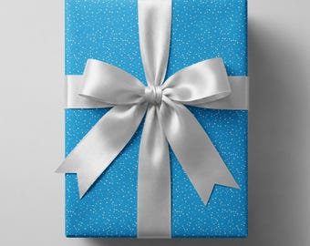 May include: A rectangular gift box wrapped in bright blue paper featuring a pattern of small white dots. The package is tied with a wide, smooth, white satin ribbon that forms a large, centered bow with four distinct loops and two tails.