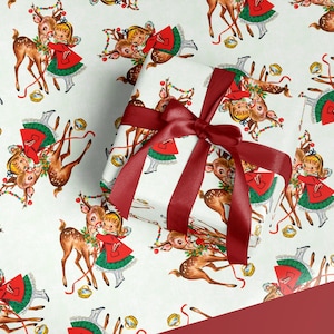 May include: White wrapping paper with a repeating pattern of vintage illustrations of a girl in a red dress with a green skirt and a reindeer. A wrapped gift with a burgundy ribbon is in the image.