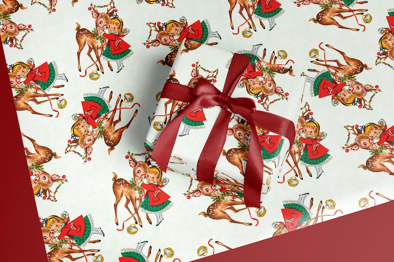 May include: White wrapping paper with a repeating pattern of vintage illustrations of a girl in a red dress with a green skirt and a reindeer. A wrapped gift with a burgundy ribbon is in the image.