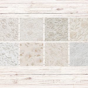May include: Eight square tiles with embossed floral patterns in shades of white, cream, and beige. The designs include roses, peonies, and other botanical elements. The tiles are arranged on a light wood background.