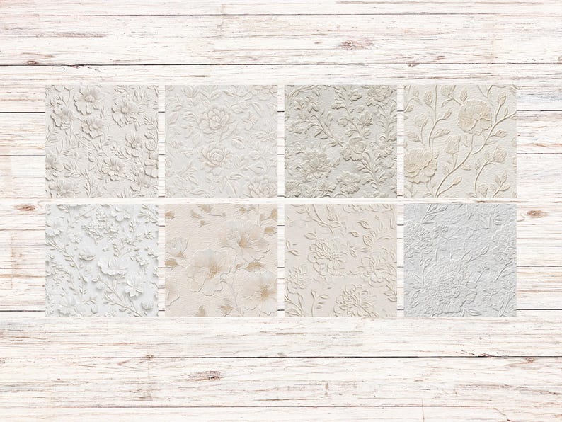 May include: Eight square tiles with embossed floral patterns in shades of white, cream, and beige. The designs include roses, peonies, and other botanical elements. The tiles are arranged on a light wood background.