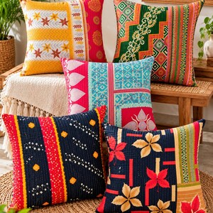 May include: Five square throw pillows featuring intricate kantha stitching and diverse patterns. The collection includes vibrant designs in yellow, red, green, blue, and black, showcasing floral, geometric, and striped motifs on quilted fabric.