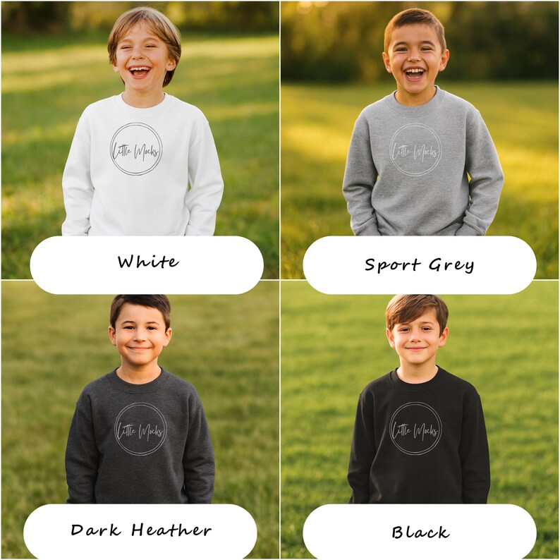 Peut inclure: Quatre sweat-shirts pour enfants, blancs, gris sport, gris fonc&eacute; et noirs. Chaque sweat-shirt pr&eacute;sente un logo circulaire avec le texte "Little Marks" dans un style manuscrit. Les sweat-shirts sont pr&eacute;sent&eacute;s sur un fond herbeux vert.