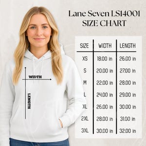 May include: A woman wearing a white hoodie, with a size chart for the Lane Seven LS14001 model. The chart shows measurements in inches for width and length, ranging from XS to 3XL. The hoodie has a front pocket and a drawstring hood.