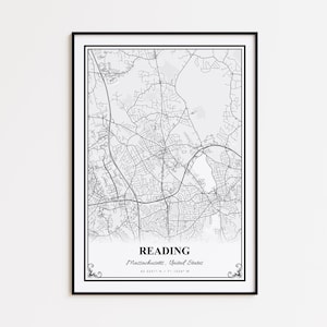 May include: A framed black and white map print of Reading, Massachusetts, United States. The map shows the road network and is labelled with the city's name and coordinates. The print has a black border and decorative flourishes.