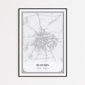 May include: A framed black and white map print of Plovdiv, Bulgaria. The map details the city's streets and infrastructure. The city name and coordinates are printed at the bottom. The print is encased in a black frame.