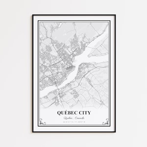 May include: A framed black and white map print of Québec City, Canada. The map details the city's layout, including roads and waterways. The city name and coordinates are printed at the bottom. The print is encased in a black frame.