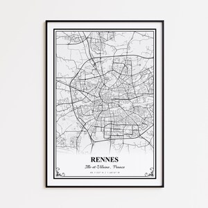 May include: A framed black and white map print of Rennes, France. The map details the city's road network and is labeled with the city name, region, and coordinates. The print is encased in a black frame with decorative corner accents.