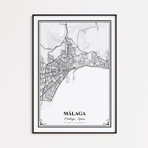 May include: Black and white framed map print of Málaga, Spain. The detailed map shows streets, buildings, and geographical features. The city name is displayed in a serif font, with coordinates below. The frame is black.