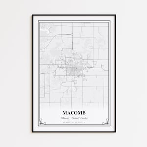 May include: A framed black and white map print of Macomb, Illinois, United States. The map shows the city's layout with roads and buildings. The text "MACOMB, Illinois, United States" is at the bottom, with coordinates.