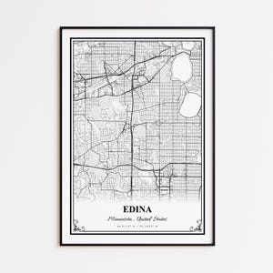 May include: A framed black and white map print of Edina, Minnesota, United States. The detailed map shows roads, buildings, and lakes. The city name and coordinates are printed at the bottom. The print is in a black frame.
