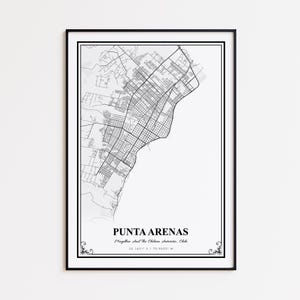 May include: A framed black and white map print of Punta Arenas, Chile. The map shows the city's street layout and is labeled with the city's name and coordinates. The print is in a black frame with decorative flourishes.