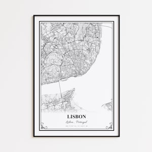 May include: Black and white framed map print of Lisbon, Portugal. The detailed city map shows streets, waterways, and landmarks. The city name and coordinates are printed at the bottom. The frame is black.