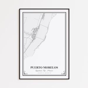 May include: Black framed print showing a detailed black and white map of Puerto Morelos, Quintana Roo, Mexico. The city's name and coordinates are displayed below the map. Decorative flourishes are at the bottom corners of the frame.
